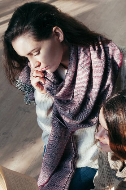 istock student girl friends sitting over a book 1478123625