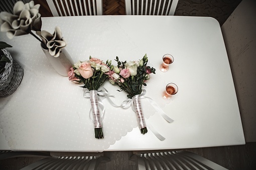 A white table adorned with a variety of pink flowers creating a romantic wedding decoration