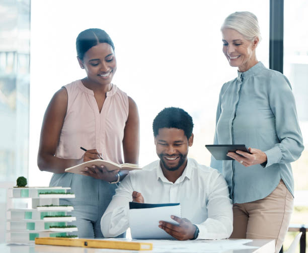 istock Architecture, strategy meeting and planning building project in construction or engineer office. Architect team, plan with builder model for contractor teamwork in a corporate office with a blueprint 1478126938