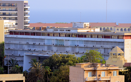 Dakar, Senegal: building of the Parliament of Senegal, the façade of the National Assembly. Colonial modernist building designed by the architects D. Badan and Roux Dorout. Completed in 1954, it was inaugurated two years later to house the Grand Council of French West Africa (AOF), representative assembly, made up of Europeans and 'natives', elected by universal suffrage and after the Legislative Assembly of the Federation of Mali (1959-1960).