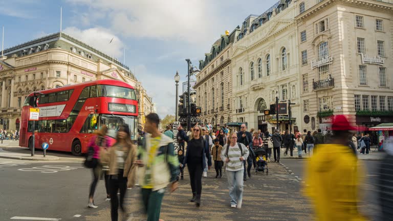 Time lapse of Crowd pedestrian and tourist waiting and crossing road junction at Piccadilly Circus near Regent Street in London, United Kingdom