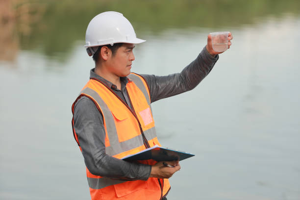 istock Environmental engineers work at water source to check for contaminants  in water sources and analysing water test results for reuse.World environment day concept. 1478127844