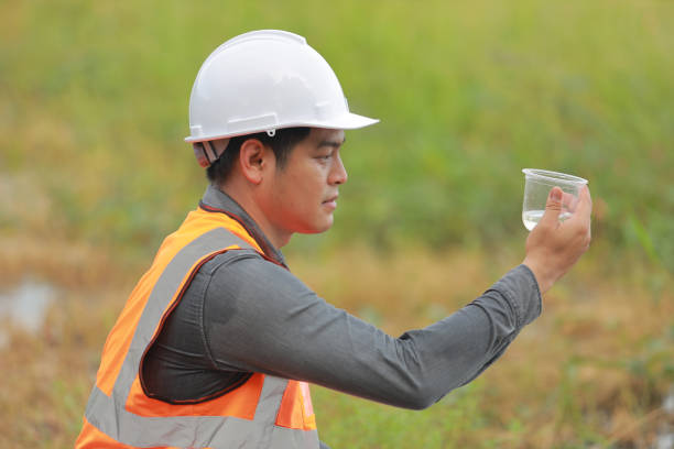 istock Environmental engineers work at water source to check for contaminants  in water sources and analysing water test results for reuse.World environment day concept. 1478127852