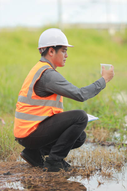 istock Environmental engineers work at water source to check for contaminants  in water sources and analysing water test results for reuse.World environment day concept. 1478127854