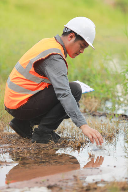 istock Environmental engineers work at water source to check for contaminants  in water sources and analysing water test results for reuse.World environment day concept. 1478127855