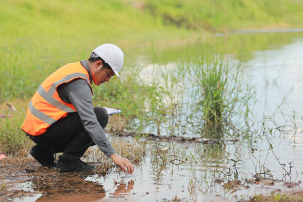 istock Environmental engineers work at water source to check for contaminants  in water sources and analysing water test results for reuse.World environment day concept. 1478127859