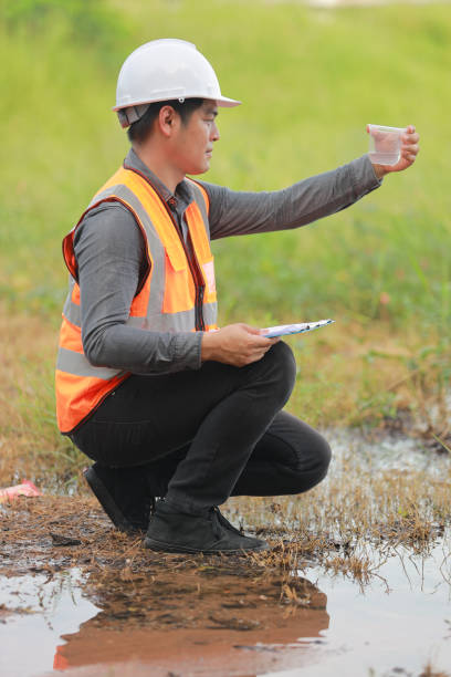 istock Environmental engineers work at water source to check for contaminants  in water sources and analysing water test results for reuse.World environment day concept. 1478127860