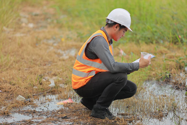 istock Environmental engineers work at water source to check for contaminants  in water sources and analysing water test results for reuse.World environment day concept. 1478127873