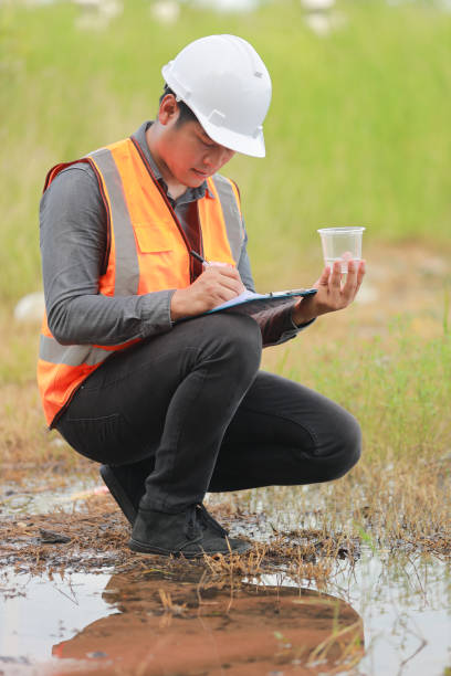istock Environmental engineers work at water source to check for contaminants  in water sources and analysing water test results for reuse.World environment day concept. 1478127875