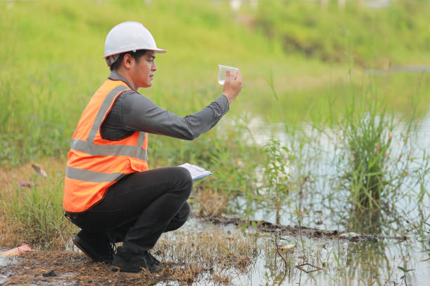 istock Environmental engineers work at water source to check for contaminants  in water sources and analysing water test results for reuse.World environment day concept. 1478127890