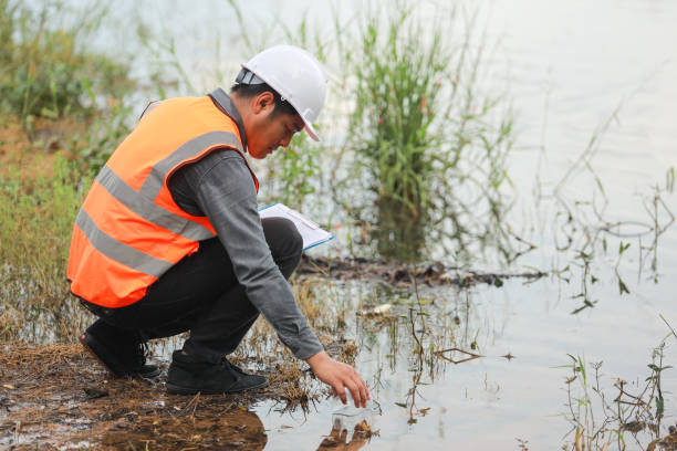 istock Environmental engineers work at water source to check for contaminants  in water sources and analysing water test results for reuse.World environment day concept. 1478127904