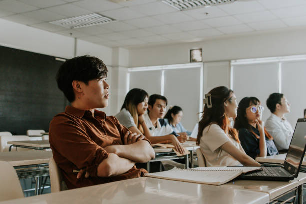 istock Group of architecture student sitting and studying in classroom together. 1478128448