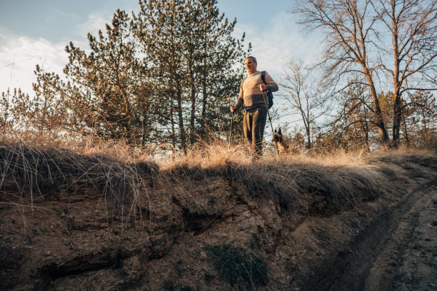 istock An elderly man walks in nature with his dog 1478129977
