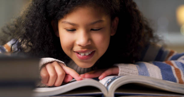 istock Child reading book for learning, education and language development, literature or story knowledge. Happy biracial girl or kid with library books or textbook for creative mind, storytelling and study 1478130101