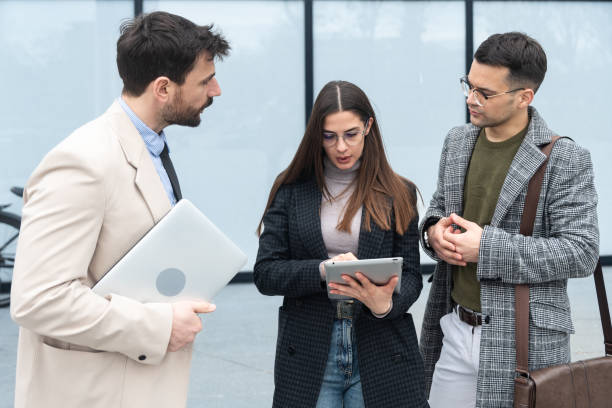 istock Group of creative business people working on social media strategy using a digital tablet. Colleagues discussing business near office building. Ideas and solutions telemarketing and telecommunication 1478130174