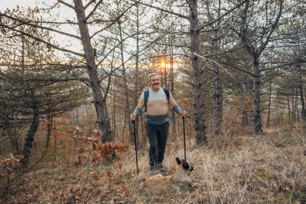 istock An active lonely elderly man is recreating, walking his dog in nature 1478130495