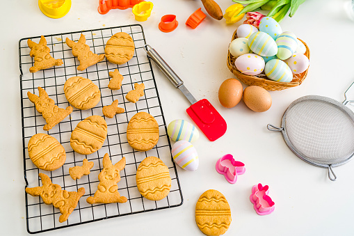 Overhead viev of ingredients and utensils used for preparing Easter cookies at home shot on kitchen counter. High resolution 42Mp studio digital capture taken with SONY A7rII and Zeiss Batis 40mm F2.0 CF lens