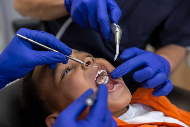 istock Dentist and his assistant working with a dark-skinned boy 1478135559