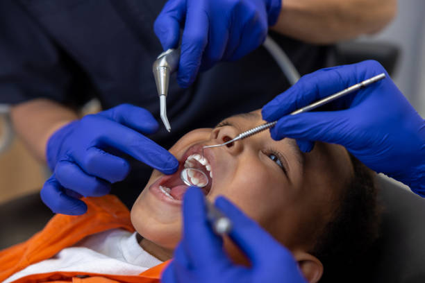 istock Dentist and his assistant working with a dark-skinned boy 1478135582