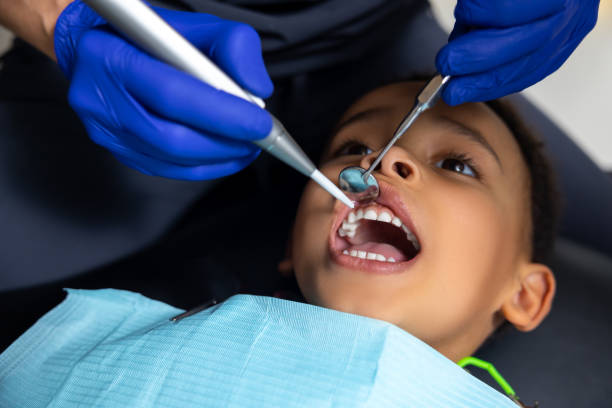 istock Dark-skinned boy looking scared of medical tools 1478135740