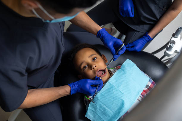 istock Dentist treating dark-skinned boys teeth 1478135798