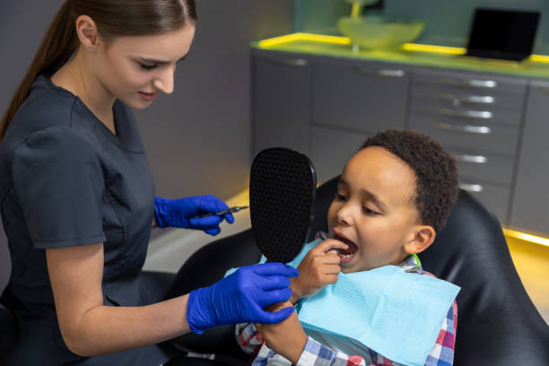 istock Doctor giving mirror to dark-skinned boy 1478135995