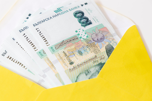 Bulgarian 100 BGN banknotes placed in a yellow envelope