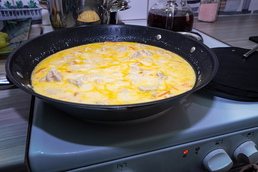 Home food, home cooking. A chicken dish in a creamy sauce is cooked in a pan