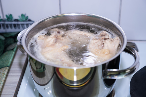 Home food, home cooking. Boiling chicken broth with meat.