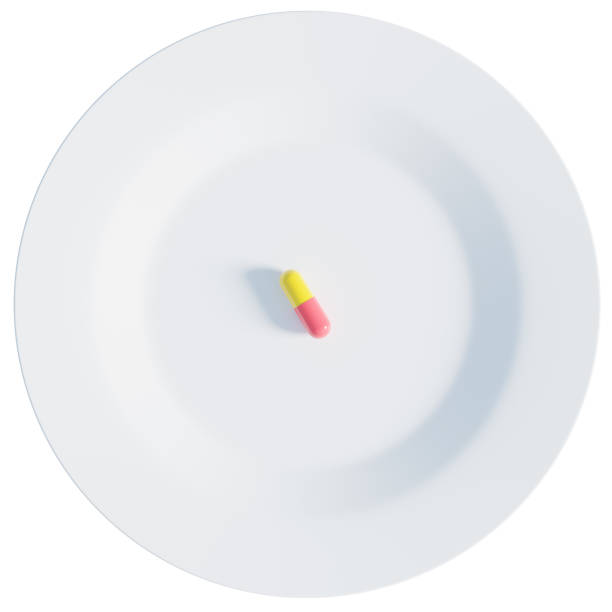 istock Single pill on a white plate, 3d rendering. Nutritional supplement, taking medication, healthcare and wellbeing concept 1478138104