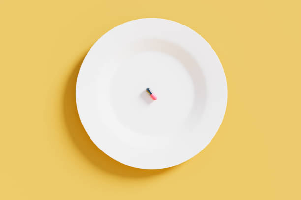 Single pill on a white plate, 3d rendering. Nutritional supplement, taking medication, healthcare and wellbeing concept