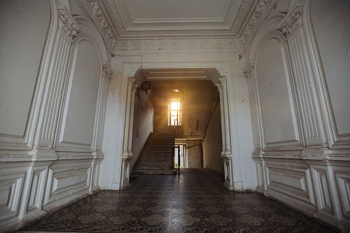 Empty ancient corridor in a an old historicism Building. Bleached colors, little grain visible.