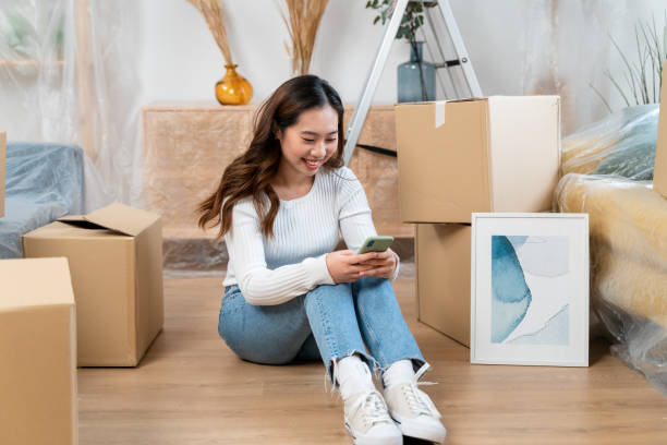 istock Happy woman using smartphone on floor 1478140671
