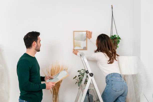 istock Happy couple unpacking boxes at home 1478143058