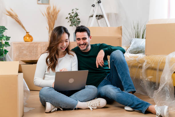 istock Happy couple using laptop on sofa 1478145623