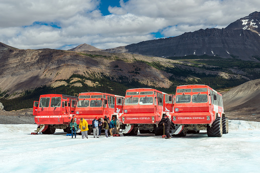 Giant Columbia Icefield trucks and tourists used for riding on ice of Athabasca glacier in Jasper national park.