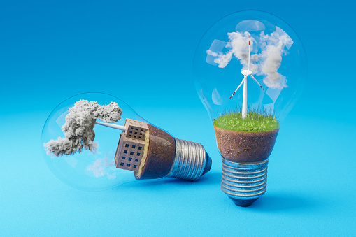 lightbulbs with minature wind turbine and coal-fired power station  inside; green soil and clouds; pollution and smoke; renewable clean energy concept; infinite background; 3D Illustration