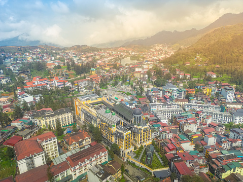 Aerial view of landscape at the hill town in Sapa city, Lao Cai Province, Vietnam in Asia with the sunny light and sunset, mountain view in the clouds. Travel and landscape concept.