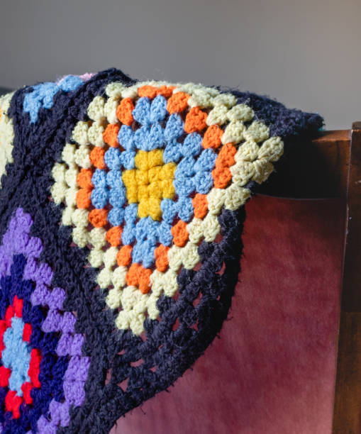 istock Hand knitted wool blanket hanging on a chair 1478153966