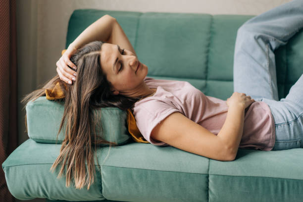 istock Relaxed woman lies on the sofa. 1478154121