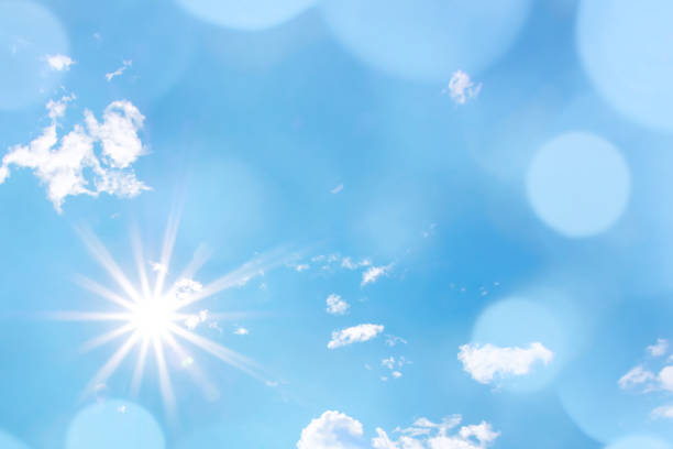 Bright sun with beautiful beams and bokeh light in the sky