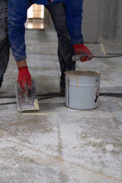 istock The professional is skillfully filling the expansion joints with epoxy mortar using a trowel and putty knife, ensuring that the material is spread evenly and completely fills the joint 1478160335