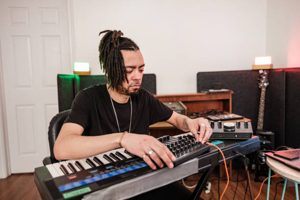 istock Male mixed race Musician practising at home recording studio 1478161327