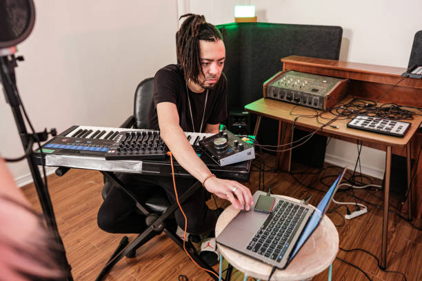 istock Male mixed race Musician practising at home recording studio 1478161360