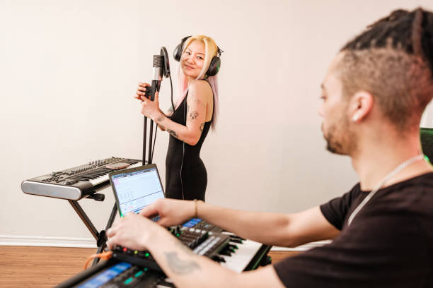 istock Multi racial Musician couple  practising at home recording studio 1478161531
