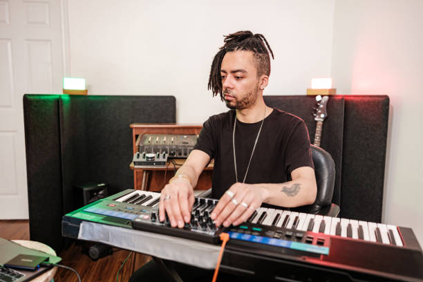 istock Male mixed race Musician practising at home recording studio 1478161532