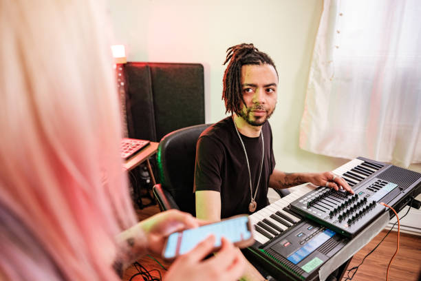 istock Multi racial Musician couple  practising at home recording studio 1478161629
