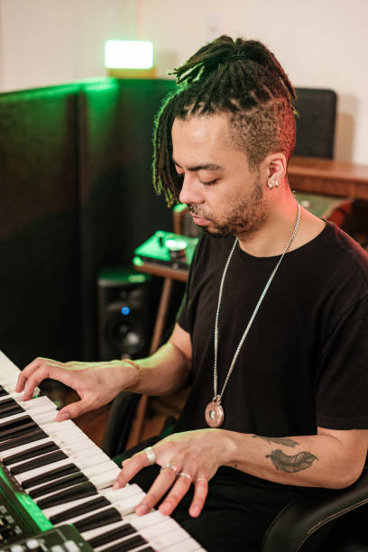 istock Male mixed race Musician practising at home recording studio 1478161952