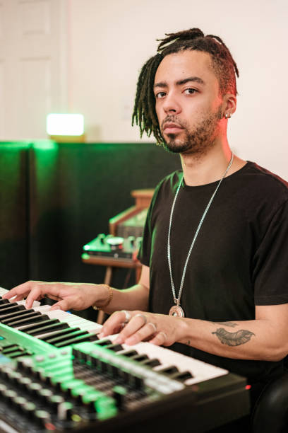 istock Male mixed race Musician practising at home recording studio 1478161964