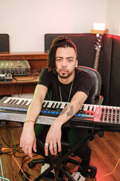 istock Male mixed race Musician practising at home recording studio 1478161975